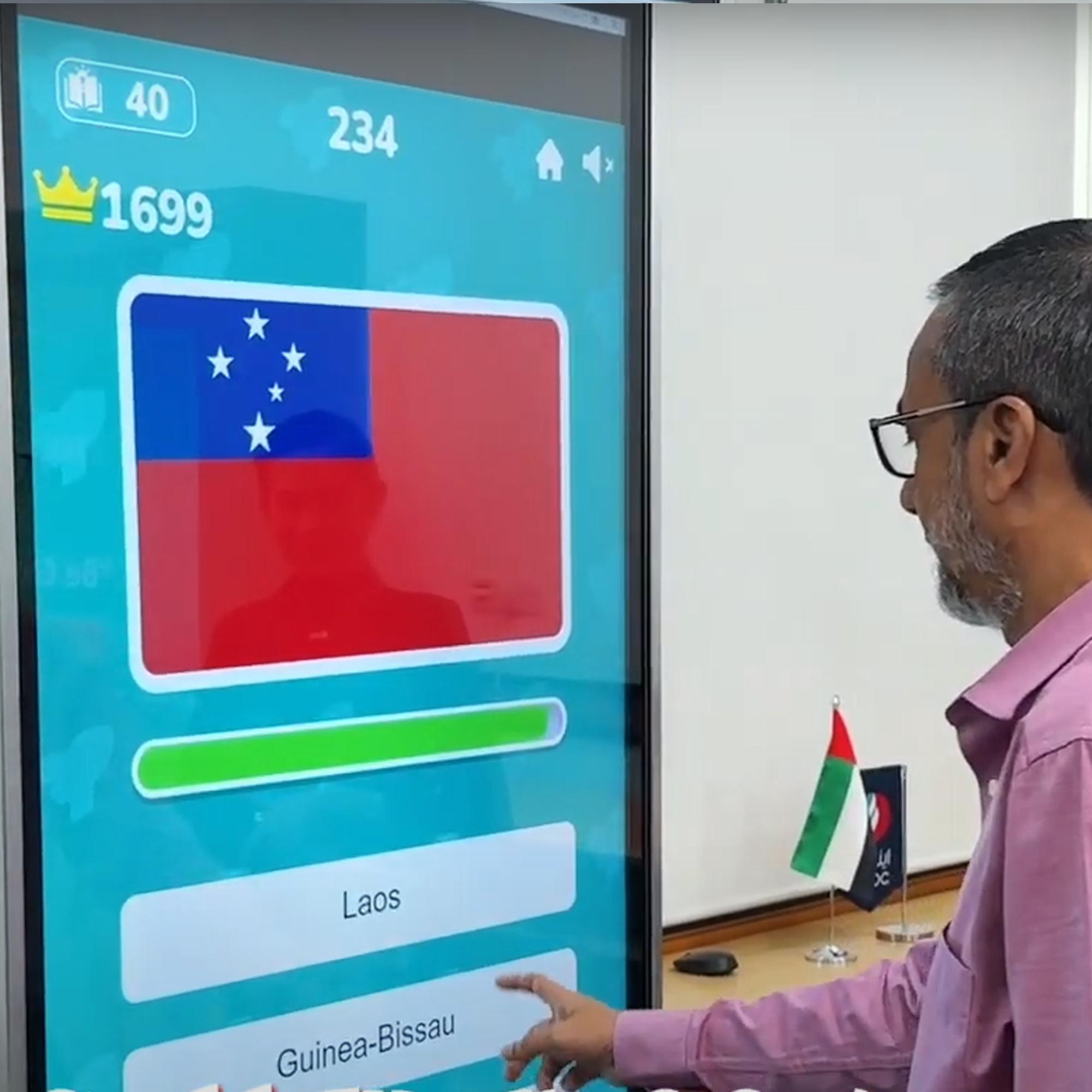 Participants playing the interactive Guess the Flag game at an event, engaging with a fun, branded quiz experience that tests geographical knowledge in a lively setting.